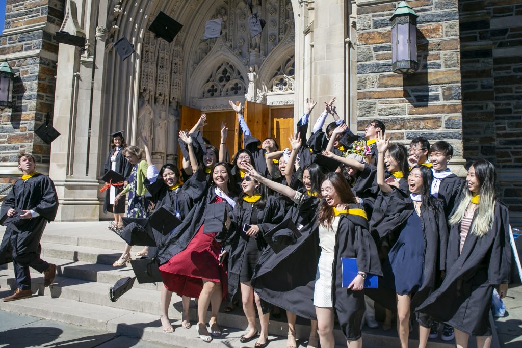 A group of graduates poses for a photo in front of Duke Chapel after the ceremony