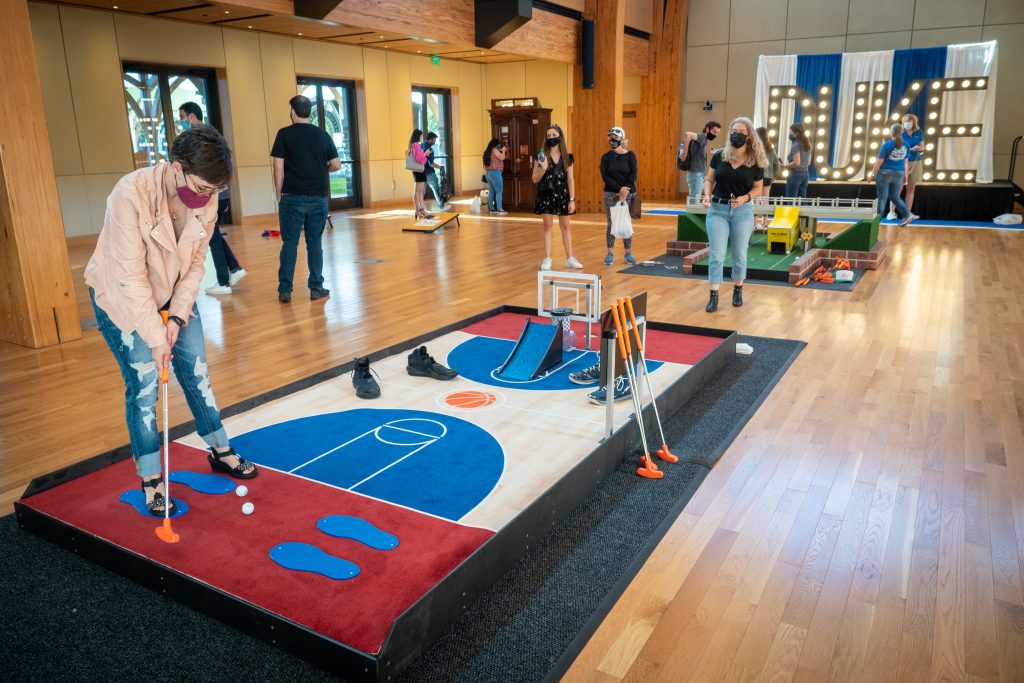 Gradautes play Duke/Durham minigolf at a welcome event at Karsh Alumni and Visitor Center