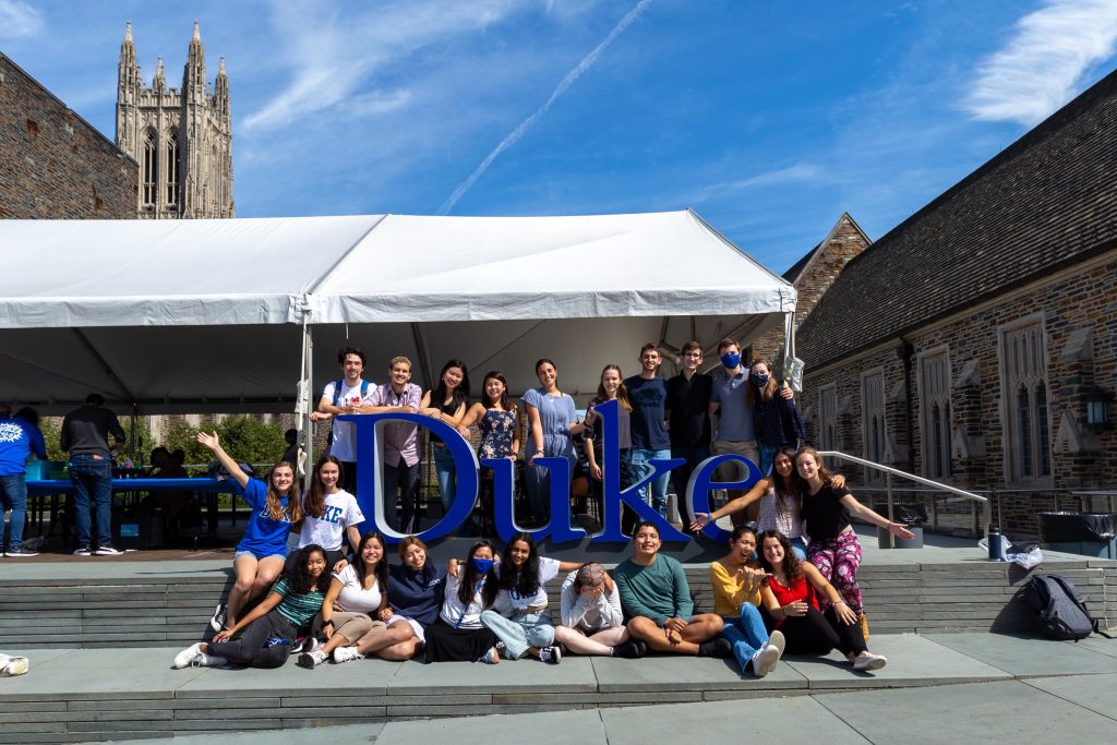 Graduates post with letters spelling out "Duke"