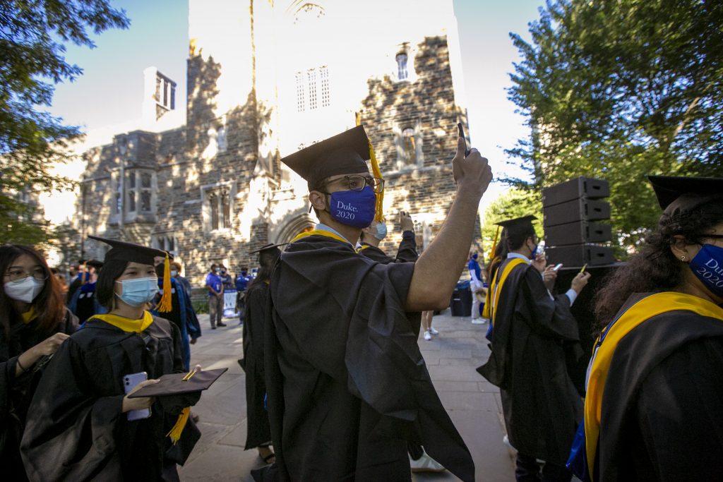 Graduates record the experience while walking for commencement