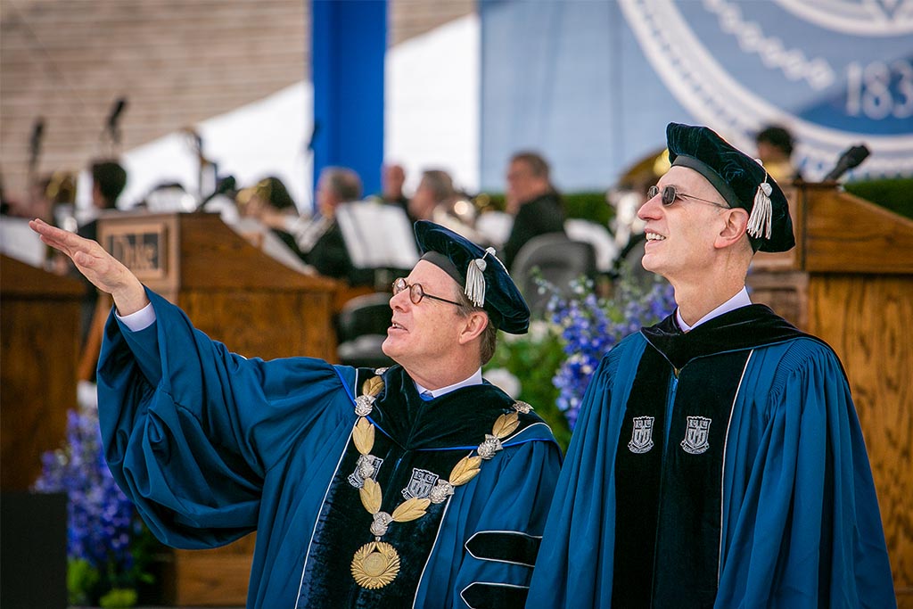 President Price and Keynote Speaker Adam Silver look out at the crowd at commencement