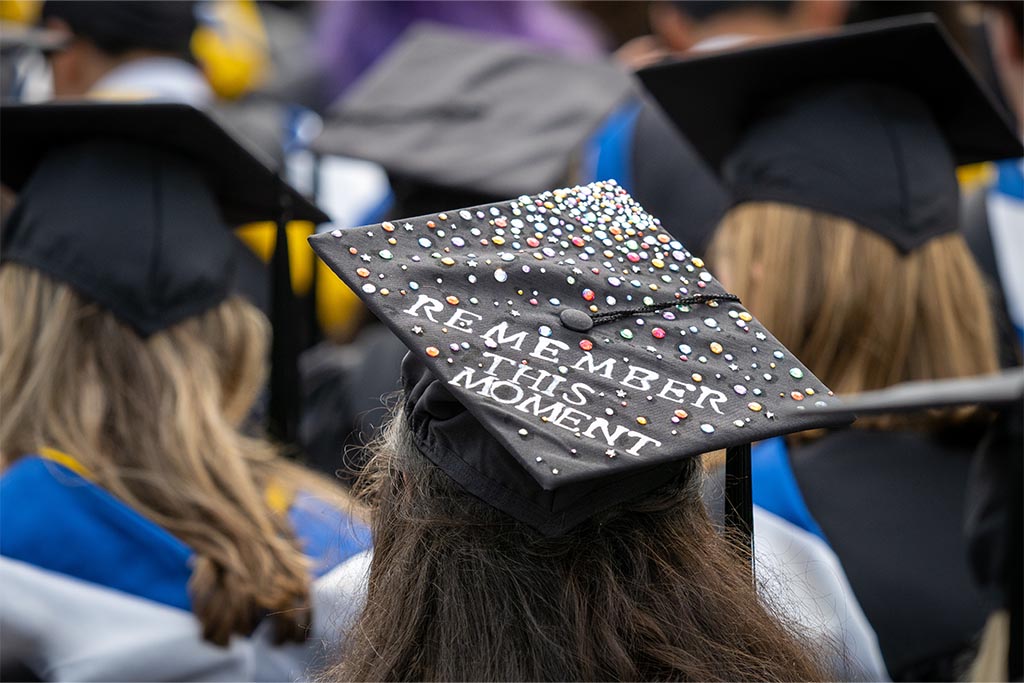A decorated mortarboard that says, “Remember this moment.”